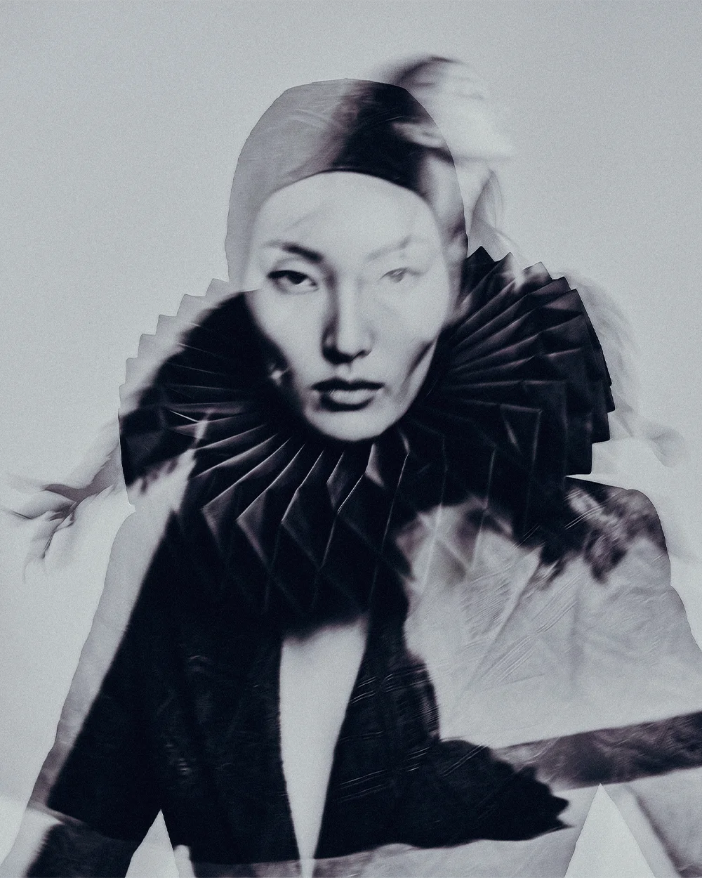 Double-exposure editorial portrait of a model wearing a pleated black ruff collar with an ethereal blurred effect – Sbranzo Alessandro Valori Studio Vago Yumi